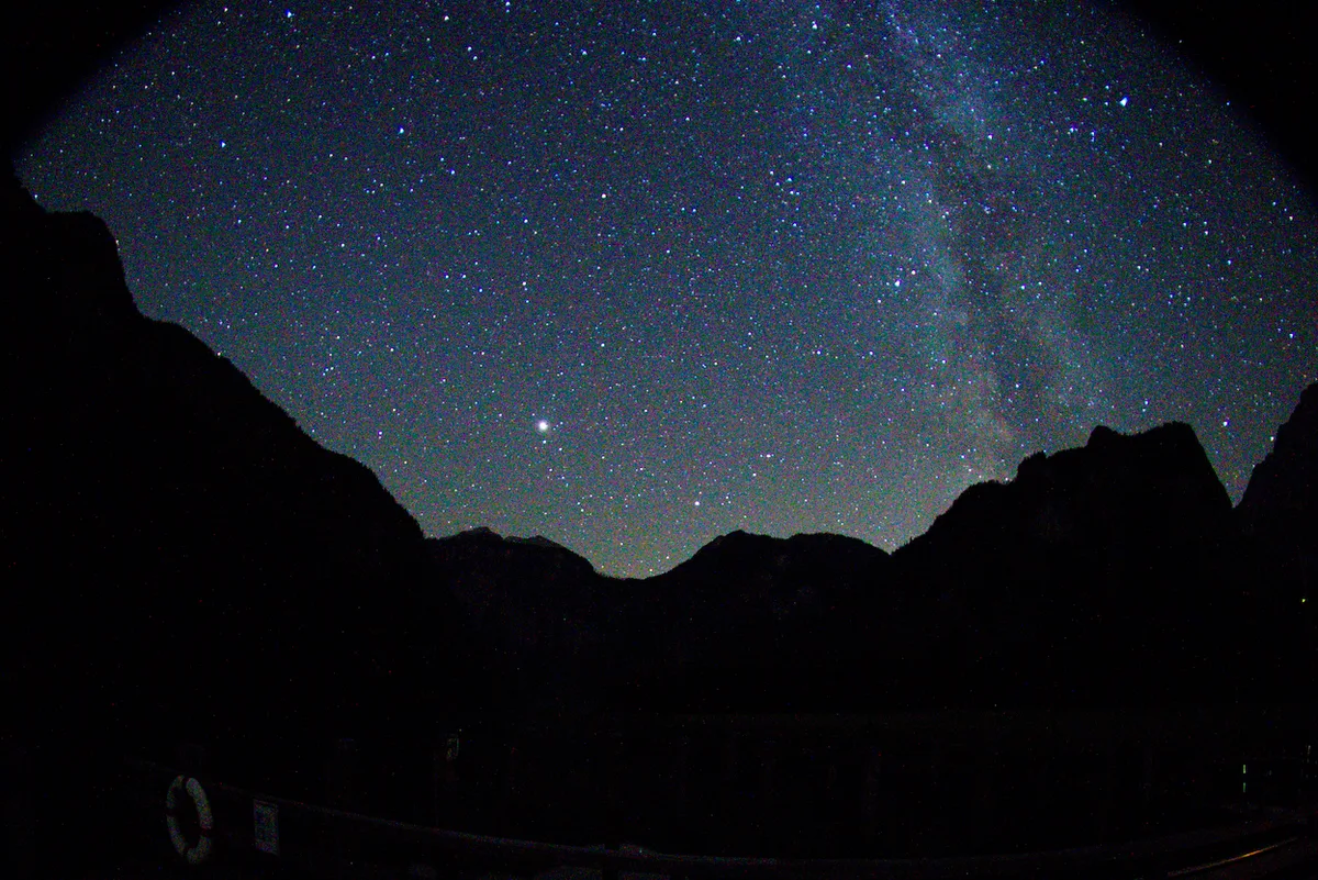 The Milky Way above a mountain ridge, developed to reveal dense star fields and cool night color